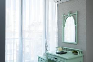 a dressing table with a mirror and a window at Wolf Suites in Antalya