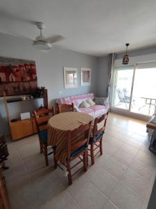 a room with a table and chairs and a dining room at Apartamento Ático Laguna Beach Almerimar in Almería