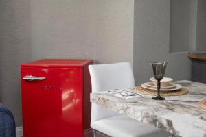 a red refrigerator next to a table with a wine glass at Wolf Suites in Antalya