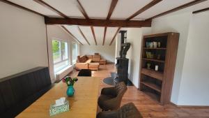 a living room with a wood stove and a couch at Maal Waldhaus in Todtnau