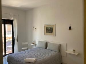 a bedroom with a bed in a white room at Dimora AnVi in Bari