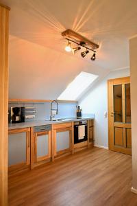 a kitchen with a skylight in the ceiling at Loft am Malerweg in Reinhardtsdorf +3 photos