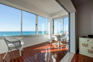 een woonkamer met uitzicht op de oceaan bij Ria Beach House in Faro
