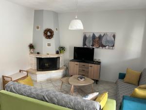 a living room with a couch and a fireplace at Apartment Efi in N&eacute;a P&eacute;ramos