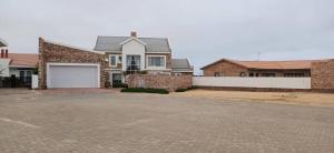 a brick house with a garage on a street at Sunbay in Hentiesbaai