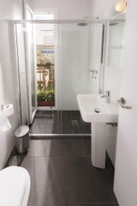 een badkamer met een toilet, een wastafel en een douche bij Tarifa Kite Hostel in Tarifa