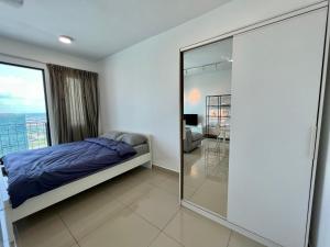 a bedroom with a bed and a sliding glass door at High Floor Suite at Trefoil Setia Alam in Shah Alam +10 photos