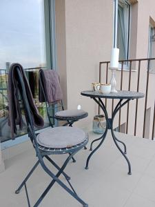 a chair and a table on a balcony at J&Z apartmán in Olomouc