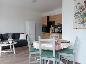 a living room with a table and chairs and a couch at J&Z apartmán in Olomouc