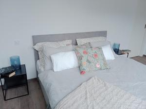 a bed with pillows on it in a bedroom at J&Z apartmán in Olomouc