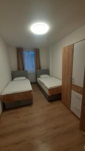 two beds in a room with a room with at Dvije lipe in Moravice