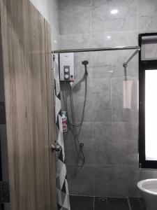 a shower stall in a bathroom with a sink at ONE DD HOMES in Udon Thani