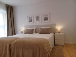 1 dormitorio con 2 camas y 2 lámparas en las mesas en Flor da Laranjeira, en Elvas