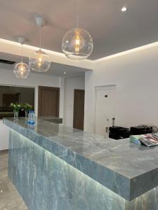 a large marble counter in a room with lights at Pavlinia Hotel & Apartments in Ayia Napa