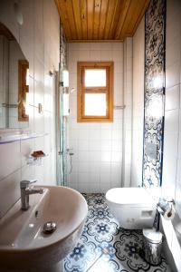 a bathroom with a tub and a sink and a toilet at COSA Zeyrek- Home at the heart of Istanbul in Istanbul