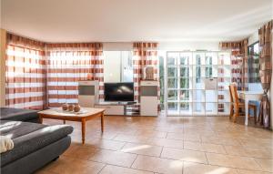 2 Bedroom Beautiful Apartment In Feldkirch في فيلدكيرخ: غرفة معيشة مع أريكة وتلفزيون وطاولة