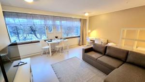 a living room with a couch and a table at Aparthotel Clock 19 in Kotka