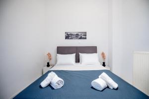 a bedroom with a bed with two towels on it at Joseph Seaside Apartment in Heraklio