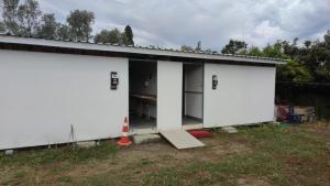 a large white building with two garage doors at Bodrum Masali Camping in Mugla