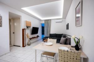 a living room with a table and a couch at Joseph Seaside Apartment in Heraklio