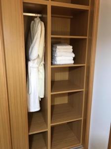 a closet with white towels and towels at JAC-Lovely new apartment in Horta Faial Island in Horta