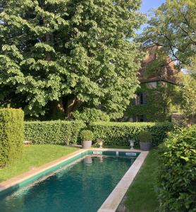 a swimming pool in the yard of a house at Maison d'hôtes - Les Tillets in Bois-Sainte-Marie