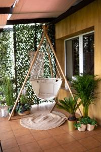 a hanging hammock in a patio with plants at Gościniec Paradise in Mierzęcice