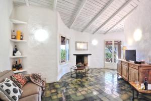 a living room with a couch and a fireplace at Volpe by DomusAway in Monte Petrosu