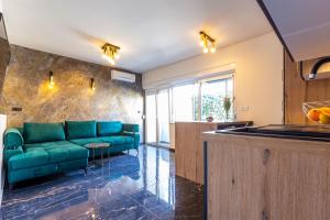 ein Wohnzimmer mit einer grünen Couch in einem Zimmer in der Unterkunft Luxury Hedone Apartment near the Bridge with Private SPA Zone in Zadar