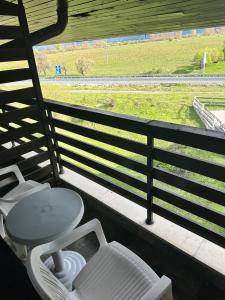 a bathroom with a toilet and a view of a field at Aspen Luxury Apartamnet in Razlog