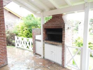 an outdoor brick fireplace on a patio at Cabañas Valeria Kaupe in Valeria del Mar