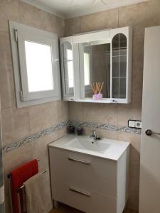 a bathroom with a sink and a mirror at Casa Roseta in Deltebre