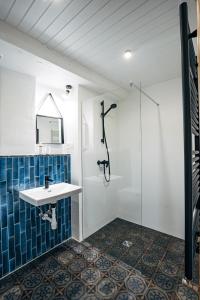 a bathroom with a sink and a shower at Constantine Apartments in Rīga
