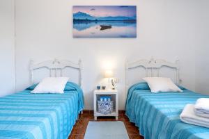 En eller flere senge i et værelse på VILLA PESCADOR