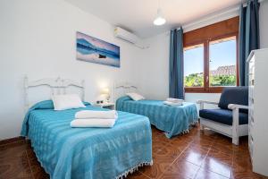 En eller flere senge i et værelse på VILLA PESCADOR