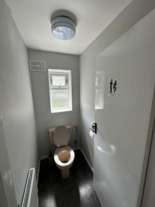 a small bathroom with a toilet and a window at 116 Maison Dieu Road Room C in Dover in Dover