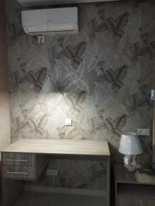 a room with a desk with butterflies on the wall at Small house in a centr in Dushanbe