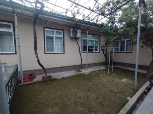 an outside view of a house with a yard at Small house in a centr in Dushanbe