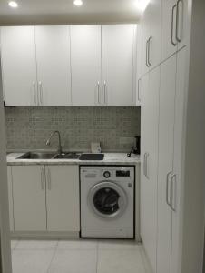 a kitchen with a washing machine and a sink at Small house in a centr in Dushanbe