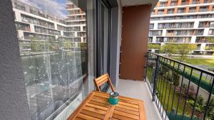 a bench on a balcony with a view of a building at 1 room Apartment with terrace, Slnečnice in Bratislava