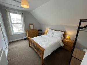 a bedroom with a large bed and a window at Dog Friendly Town House in Paignton