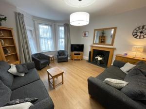 a living room with a couch and a fireplace at Dog Friendly Town House in Paignton