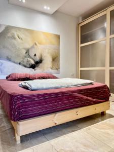 a bed with two polar bears on the wall at Retro Chic 2BR Apartment with patio in a world class compound Madinty in Madinaty