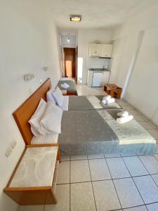 a large room with two beds and a kitchen at Cretan Sun in Platanes