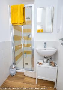 a bathroom with a sink and a shower at CINQUE OTTAVI B&B in Santa Marinella