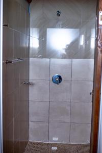 a shower with a glass door in a bathroom at 66 Anglers in Richards Bay