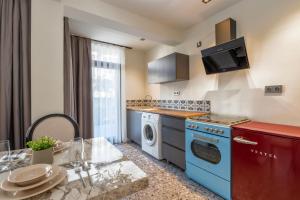 a kitchen with a washer and dryer and a table at Wolf Suites in Antalya