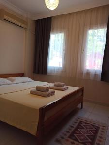 a bedroom with a bed with two towels on it at Işıl Suit Apart Otel in Dalyan +151 photos