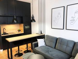 uma sala de estar com um sofá e uma mesa em Apartimento Hydral Fiori em Breslávia