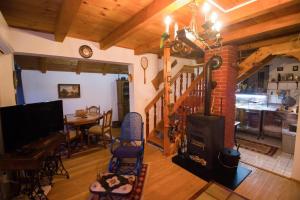 a living room with a fireplace and a dining room at Planinska kuća Agroturizam Kućica Mostar in Mostar